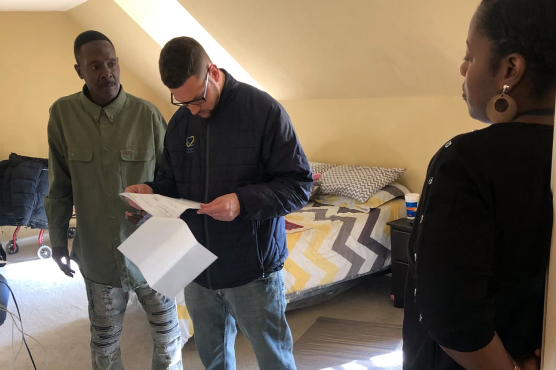 Photo: Larry Moore (left) meets with Camden Coalition housing coordinator Brian Thompson and coalition nurse Jeneen Skinner in his apartment in Camden, New Jersey.